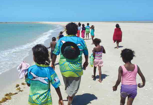 1612.jpg Young Lama Lama people walking along a white-sand beach