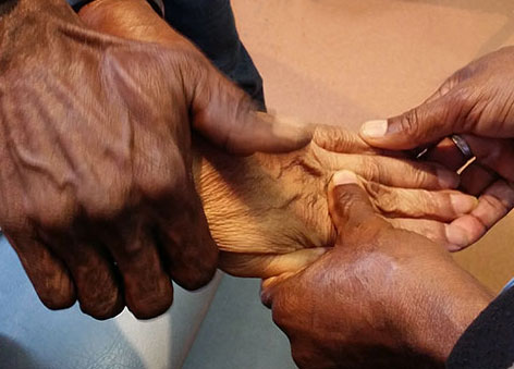 hands-cover.jpg three hands massaging a fourth