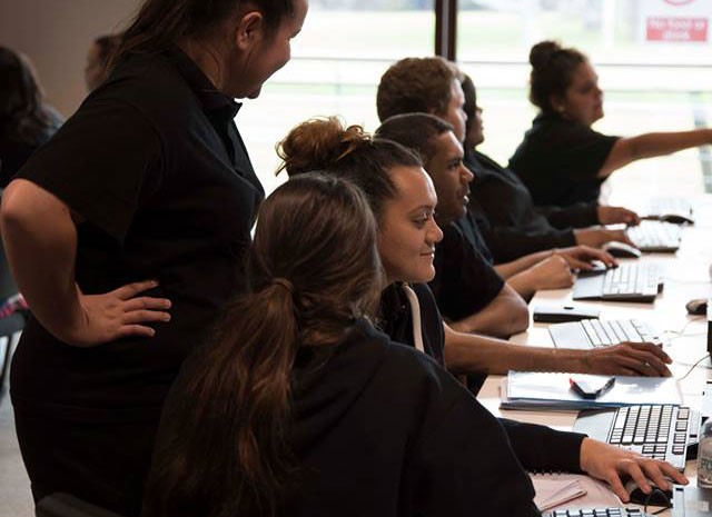 A row of Aboriginal students studying health in a computer lab