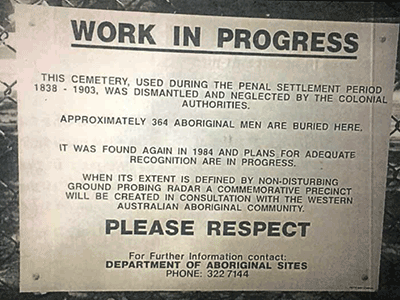 Temporary sign headed 'WORK IN PROGRESS' acknowledging the extent of the burial site is unknown and urging passers-by to PLEASE RESPECT