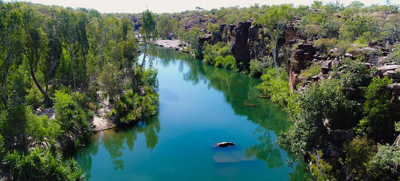 North Kimberley landscape showing a still river water in a bushy gorge