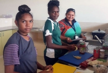 food-prep-crop.jpg Three young Aboriginal women preparing food in a kitchen