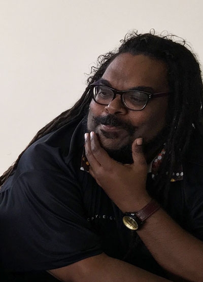 A man poses, looking to the left