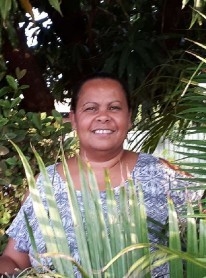 A woman smiles at the camera
