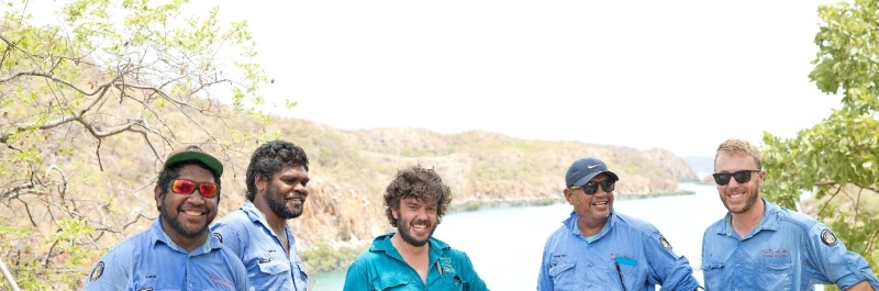 A group of people smile at the camera
