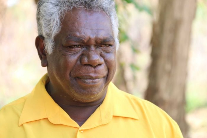 An Aboriginal man in a yellow shirt