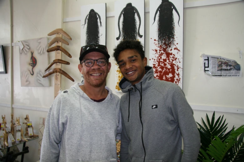 Two people smile at the camera