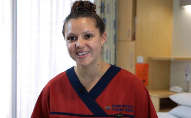 A young person wearing scrubs