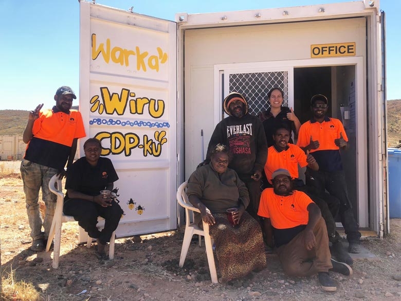 A group of people outside a small office