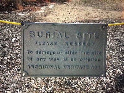 A plaque noting a burial site and asking visitors to respect it