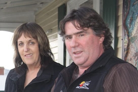 A man and a woman posing for the camera