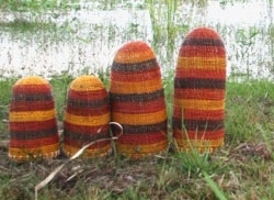 Four colourful dome-shaped sculptures in an outdoor setting