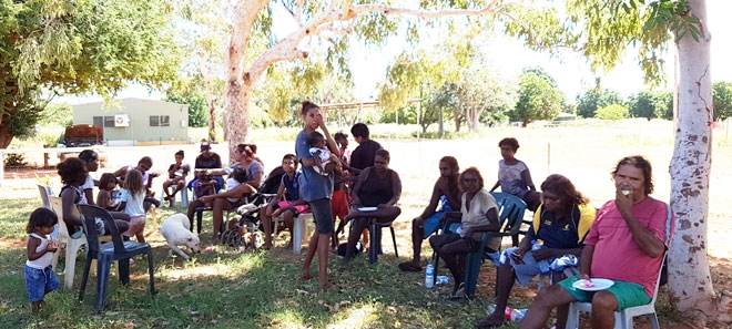 A group of people sitting in an outdoor area