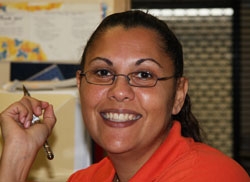 A woman smiles at the camera