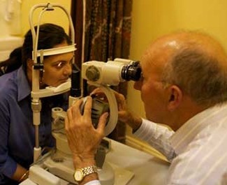 A doctor examines a person's eyes with a machine