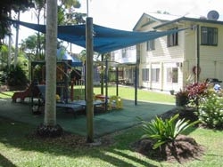 An outdoor playground covered with a shade sail