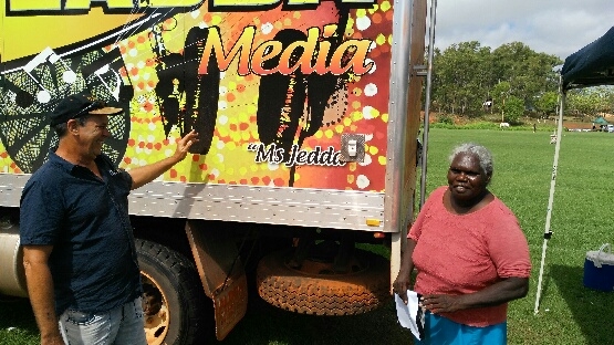 Two people and a brightly-coloured truck