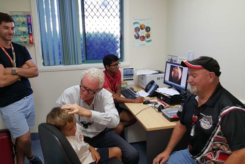 A doctor examines a child's ear