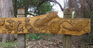 A wooden sign with carved images of sea creatures