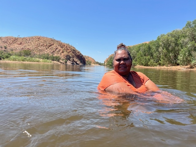 An Aboriginal woman in a river