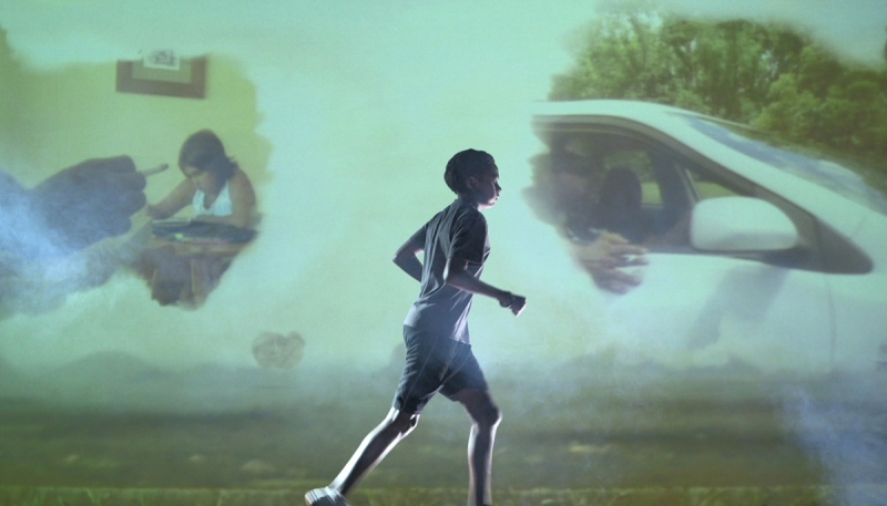 A boy running. In the background are images of smoking