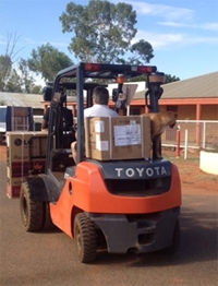 A forklift with boxes on the back and front
