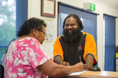 Two people sitting across a desk from each other