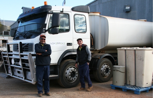 Two men stand beside a truck