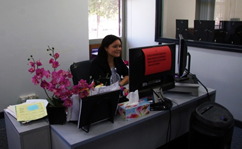 A woman sits at a desk