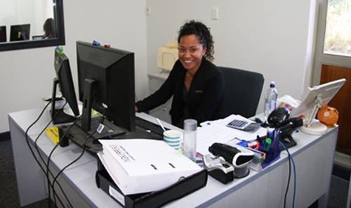 A woman sits at a desk