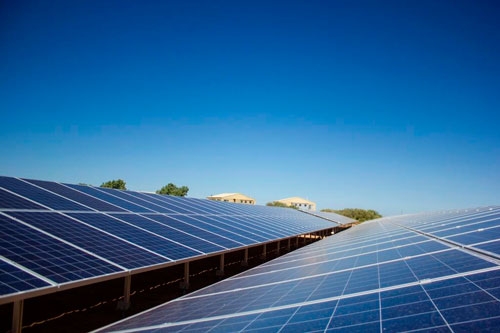 Solar panels below a blue sky