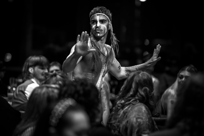 A black and white photo of an Aboriginal man dancing