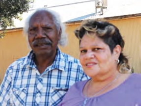 A man and a woman face the camera
