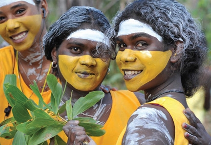 Three girls wearing face paint pose for the camera