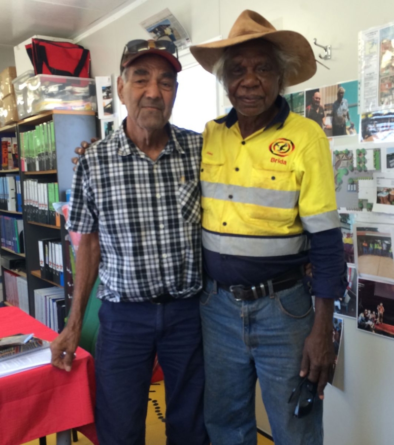 Two men pose for the camera