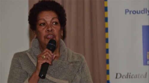 A woman speaking into a microphone