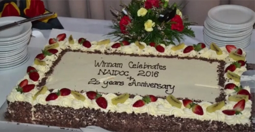 A large cake with the words 'Winnam celebrates NAIDOC + 25 years anniversary' on the top