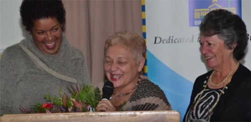 Three people smiling at each other