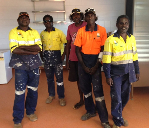 A small group of people wearing hi vis