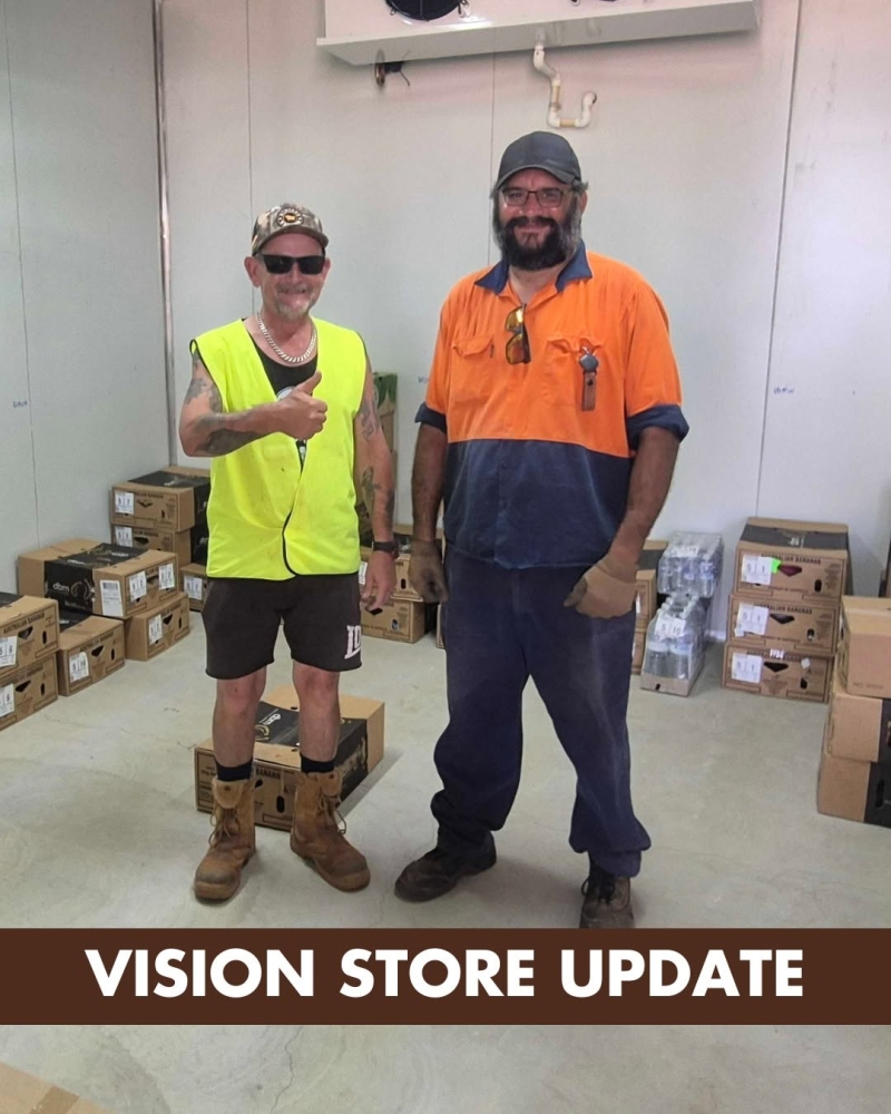 Two men in hi vis stand in an industrial room